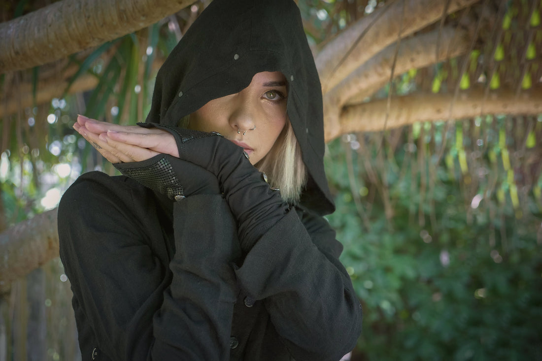 woman against a tree wearing Psylo Fashion streetwear hoodie and long gloves
