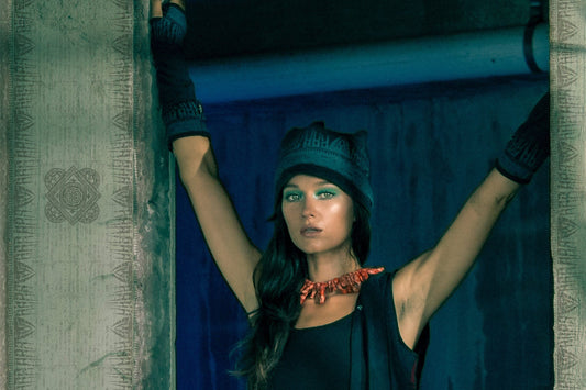 Woman standing in doorway wearing 'Jaya' design beanie and gloves