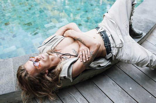 Alternative Tulum Travel Guide: a guy wearing Psylo chilling by a pool