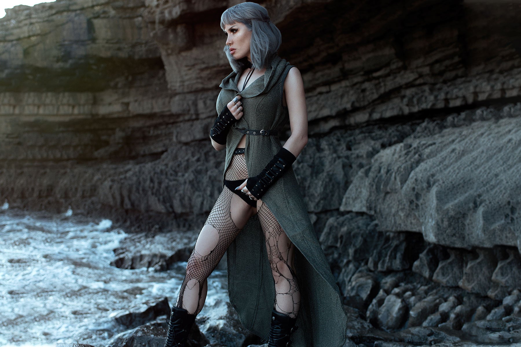 woman on a rocky beach wearing boho-chic gothic clothing by Alekai